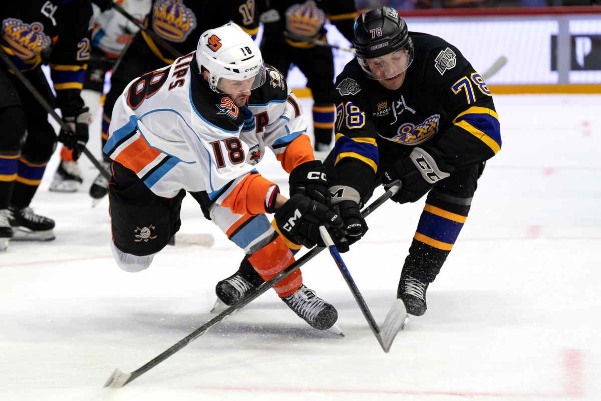 Gulls forward Matthew Phillips (18) and Reign forward Jared Wright (25) battle for the puck during an AHL hockey game, Wednesday October 14, 2026 in San Diego, California.