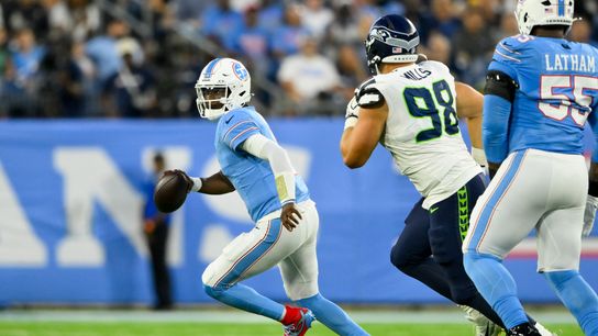 Aug 23, 2026; Nashville, Tennessee, USA; Tennessee Titans quarterback Cam Ward (1) scrambles as Seattle Seahawks defensive tackle Rylie Mills (98) chases during the first half at Nissan Stadium. Aug 23, 2026; Nashville, Tennessee, USA; Tennessee Titans quarterback Cam Ward (1) scrambles as Seattle Seahawks defensive tackle Rylie Mills (98) chases during the first half at Nissan Stadium.