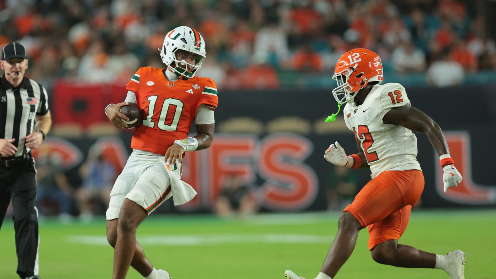 Sep 10, 2026; Miami Gardens, Florida, USA; Miami Hurricanes quarterback Darian Mensah (10) runs with the ball in the second quarter against the Florida A&M Rattlers at Hard Rock Stadium Sep 10, 2026; Miami Gardens, Florida, USA; Miami Hurricanes quarterback Darian Mensah (10) runs with the ball in the second quarter against the Florida A&M Rattlers at Hard Rock Stadium