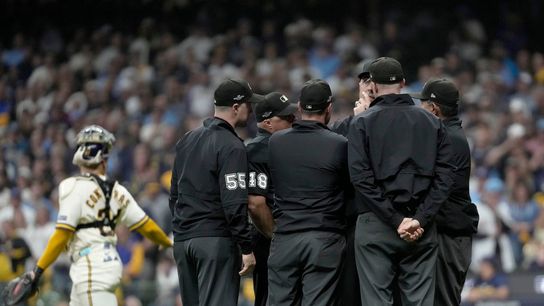 Umpires meet to discuss the fly ball hit by San Diego Padres first baseman Ty France (25) that hit a wire during the ninth inning of their National League Division Series game against the Milwaukee Brewers at American Family Field on Oct 3, 2026. Umpires meet to discuss the fly ball hit by San Diego Padres first baseman Ty France (25) that hit a wire during the ninth inning of their National League Division Series game against the Milwaukee Brewers at American Family Field on Oct 3, 2026.
