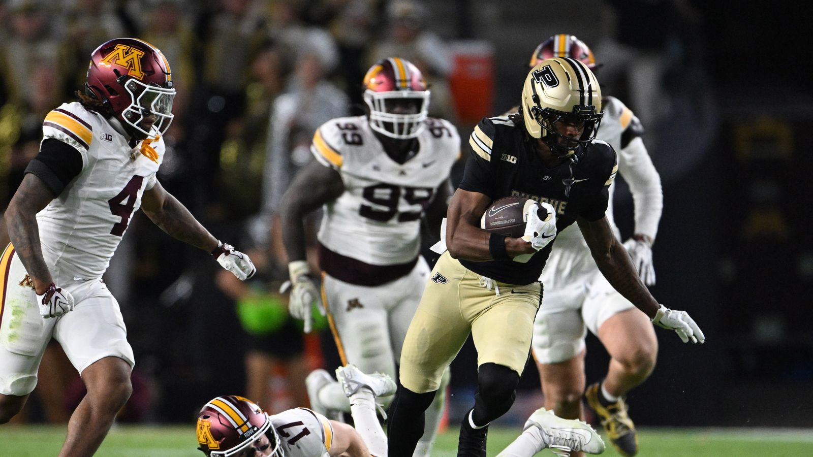 Oct 10, 2026; West Lafayette, Indiana, USA; Purdue Boilermakers wide receiver Tra'mar Harris (11) escapes tackle by Minnesota Golden Gophers defensive back John Nestor (17) during the second half at Ross-Ade Stadium.