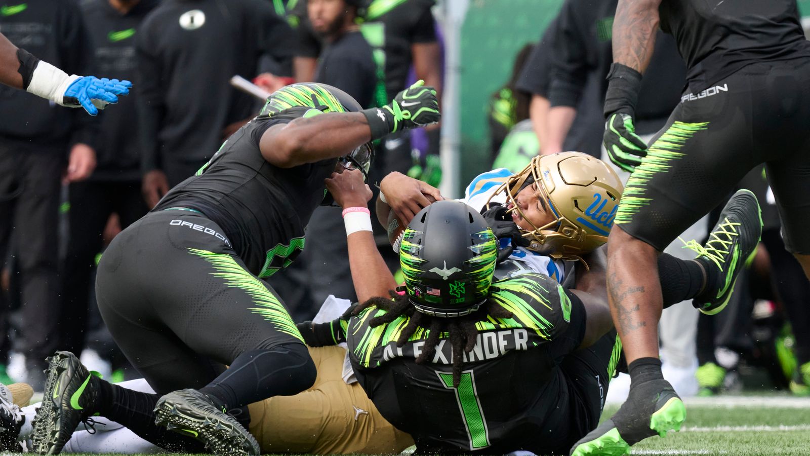 Oct 10, 2026; Eugene, Oregon, USA; UCLA Bruins quarterback Nico Iamaleava (9) is injured on a play as he is tackled by Oregon Ducks defensive lineman Bear Alexander (1) during the first half at Autzen Stadium.