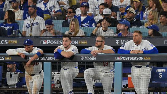 Oct 14, 2026; Los Angeles, California, USA; Los Angeles Dodgers second baseman Miguel Rojas (72) and outfielder Kyle Tucker (23) and third baseman Max Muncy (13) and first baseman Freddie Freeman (5) look on from the dugout during the eighth inning against the Milwaukee Brewers in game three of the NLCS for the 2026 MLB Playoffs at Uniqlo Field at Dodger Stadium.