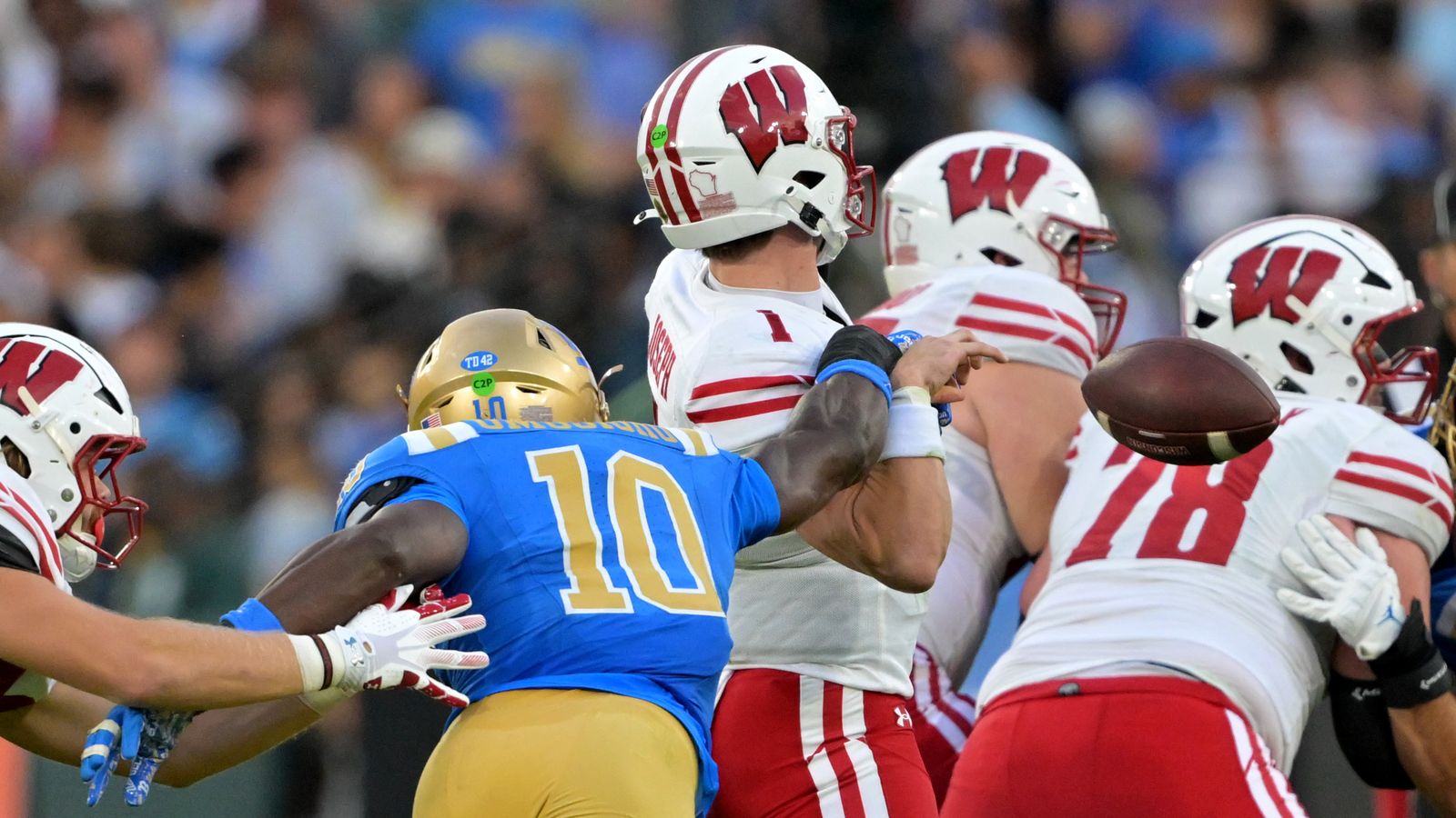 Oct 17, 2026; Pasadena, California, USA; UCLA Bruins linebacker Sammy Omosigho (10) forces an incomplete pass by Wisconsin Badgers quarterback Colton Joseph (1) in the second half at the Rose Bowl. Oct 17, 2026; Pasadena, California, USA; UCLA Bruins linebacker Sammy Omosigho (10) forces an incomplete pass by Wisconsin Badgers quarterback Colton Joseph (1) in the second half at the Rose Bowl.
