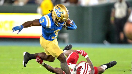 Oct 17, 2026; Pasadena, California, USA; UCLA Bruins running back Wayne Knight (3) runs for a first down before he is stopped by Wisconsin Badgers cornerback Bryce West (5) in the second half at the Rose Bowl. Oct 17, 2026; Pasadena, California, USA; UCLA Bruins running back Wayne Knight (3) runs for a first down before he is stopped by Wisconsin Badgers cornerback Bryce West (5) in the second half at the Rose Bowl.