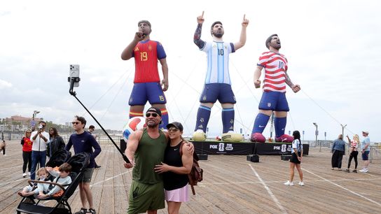 Fans pose with FOX Sports GIANTS OF THE GAME inflatable clones of Lamine Yamal, Lionel Messi and Christian Pulisc at Santa Monica Pier on May 28, 2026