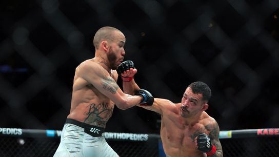 Apr 12, 2025; Miami, Florida, UNITED STATES; Dan Ige (red gloves) fights against Sean Woodson (blue gloves) during UFC 314 at Kaseya Center.