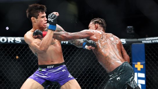 Jul 19, 2025; New Orleans, Louisiana, UNITED STATES; Michael Johnson (red gloves) fights against Daniel Zellhuber (blue gloves) during UFC 318 at Smoothie King Center.