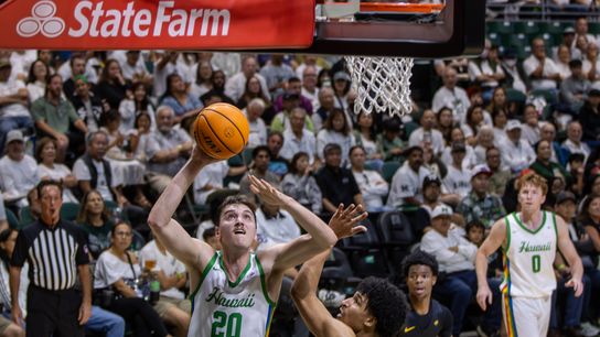 Hawaii C Isaac Johnson goes up for a dunk during a home game.