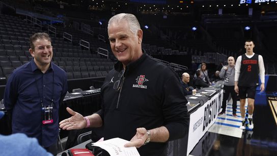 San Diego State head coach Brian Dutcher smiles as he talks with broadcasters during practice in preparation for their East semifinal game against Connecticut at TD Garden. San Diego State head coach Brian Dutcher smiles as he talks with broadcasters during practice in preparation for their East semifinal game against Connecticut at TD Garden.