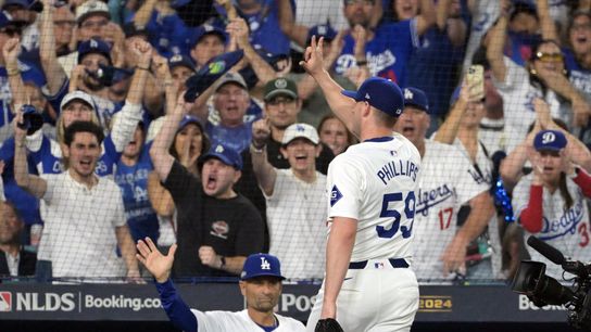 Los Angeles Dodgers pitcher Evan Phillips (59) reacts after being relieved in the seventh inning against the San Diego Padres during game five of the NLDS for the 2024 MLB Playoffs at Dodger Stadium. 
