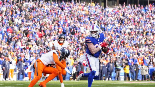 Jan 12, 2025; Orchard Park, New York, USA; Buffalo Bills tight end Dalton Kincaid (86) is tackled by Denver Broncos safety P.J. Locke (6) during the third quarter in an AFC wild card game at Highmark Stadium.