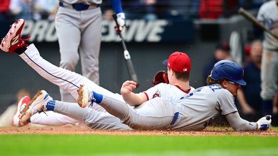 Los Angeles Dodgers first baseman Kike Hernandez (8) scores on a wild pitch as Cleveland Guardians relief pitcher Tim Herrin (29) defends the plate during the seventh inning at Progressive Field.