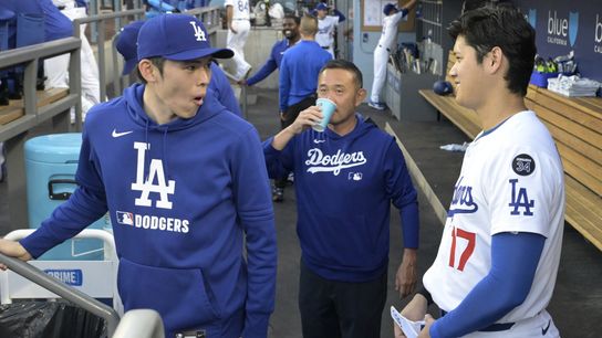 Los Angeles Dodgers designated hitter Shohei Ohtani (17) laughs with starting pitche Roki Sasaki (11) and trainer Yosuke Nakajima in the dugout prior to the game against the San Diego Padres at Dodger... Los Angeles Dodgers designated hitter Shohei Ohtani (17) laughs with starting pitche Roki Sasaki (11) and trainer Yosuke Nakajima in the dugout prior to the game against the San Diego Padres at Dodger...