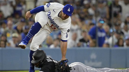 Los Angeles Dodgers third baseman Max Muncy (13) flips over Chicago White Sox right fielder Michael A. Taylor (21) after tagging him out on an attempted steal in the fifth inning at Dodger Stadium. Los Angeles Dodgers third baseman Max Muncy (13) flips over Chicago White Sox right fielder Michael A. Taylor (21) after tagging him out on an attempted steal in the fifth inning at Dodger Stadium.