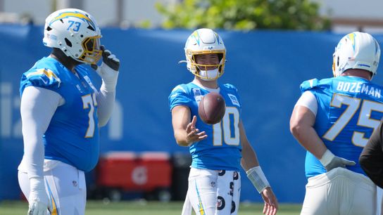 Los Angeles Chargers quarterback Justin Herbert (10) talks with guard Mekhi Becton (73) and center Bradley Bozeman (75) during training camp at The Bolt. 