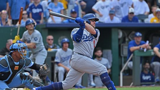 Los Angeles Dodgers third baseman Max Muncy (13) drives in a run with a single in the ninth inning against the Kansas City Royals at Kauffman Stadium. 