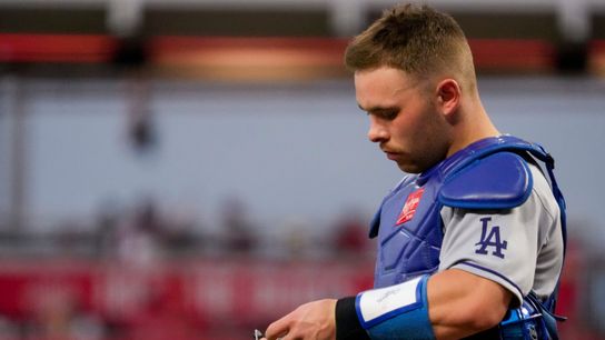 Los Angeles Dodgers catcher Dalton Rushing (68) experiences technical difficulties with his electronic pitch communicator in the first inning of the MLB National League game between the Cincinnati Red... 