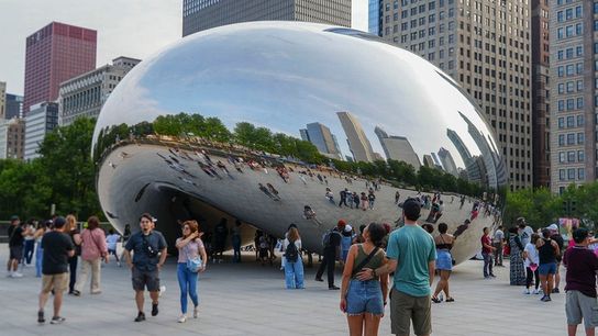 Visitors take photos around Cloud Gate, known as The Bean, in downtown Chicago. Visitors take photos around Cloud Gate, known as The Bean, in downtown Chicago.