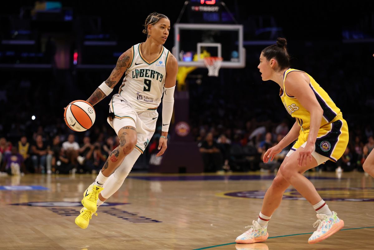 Aug 12, 2025; Los Angeles, California, USA; New York Liberty guard Natasha Cloud (9) dribbles the ball against Los Angeles Sparks guard Kelsey Plum (10) during the third quarter at Crypto.com Arena.