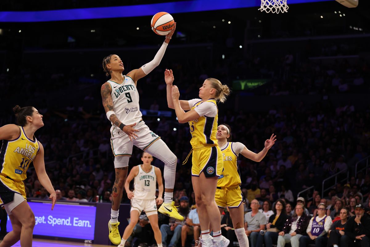 Aug 12, 2025; Los Angeles, California, USA; New York Liberty guard Natasha Cloud (9) goes to the basket against Los Angeles Sparks guard Julie Vanloo (35) during the fourth quarter at Crypto.com Arena.