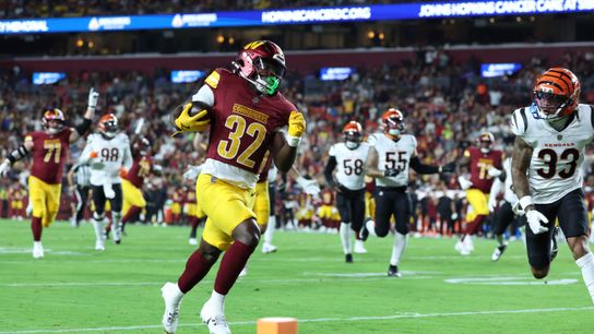 Aug 18, 2025; Landover, Maryland, USA; Washington Commanders running back Jacory Croskey-Merritt (32) scores a touchdown past Cincinnati Bengals safety Daijahn Anthony (33) during the first half at Northwest Stadium.