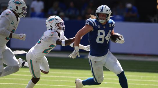 Sep 7, 2025; Indianapolis, Indiana, USA; Indianapolis Colts tight end Tyler Warren (84) runs against Miami Dolphins linebacker Bradley Chubb (2) and cornerback Jack Jones (23) during the second half at Lucas Oil Stadium.