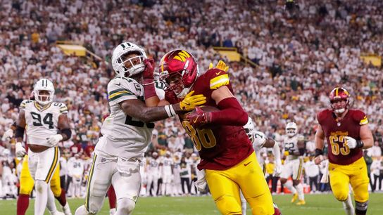 Washington Commanders tight end Zach Ertz (86) stiff-arms Green Bay Packers safety Xavier McKinney (29) as he fights to score a touchdown on Thursday, September 11, 2025, at Lambeau Field in Green Bay, Wis. The Packers won the game, 27-18.