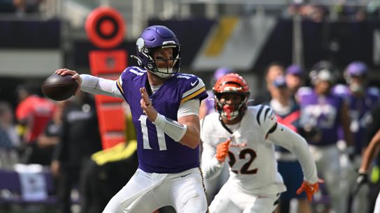 Sep 21, 2025; Minneapolis, Minnesota, USA; Minnesota Vikings quarterback Carson Wentz (11) throws downfield against the Cincinnati Bengals during the first half at U.S. Bank Stadium. 