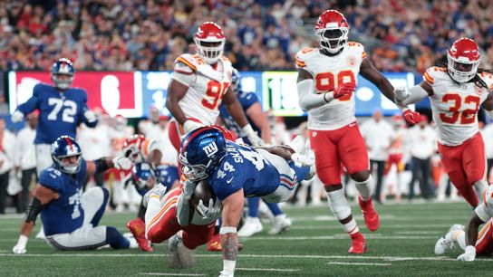 Sep 21, 2025; East Rutherford, New Jersey, USA; New York Giants running back Cam Skattebo (44) scores a touchdown against Kansas City Chiefs cornerback Christian Roland-Wallace (30) in the second quarter at MetLife Stadium.