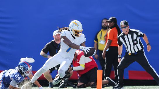 Sep 28, 2025; East Rutherford, New Jersey, USA; Los Angeles Chargers wide receiver Quentin Johnston (1) scores a touchdown as New York Giants safety Dane Belton (24) defends during the second quarter at MetLife Stadium.