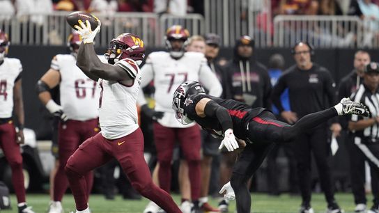 Sep 28, 2025; Atlanta, Georgia, USA; Washington Commanders wide receiver Deebo Samuel Sr. (1) makes a catch against Atlanta Falcons free safety Jessie Bates (3) during the second half at Mercedes-Benz Stadium.