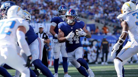Sep 28, 2025; East Rutherford, New Jersey, USA; New York Giants running back Cam Skattebo (44) runs with the ball against the Los Angeles Chargers during the fourth quarter at MetLife Stadium.
