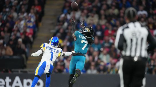 Oct 19, 2025; London, United Kingdom; Jacksonville Jaguars wide receiver Brian Thomas Jr. (7) reaches for the ball against Los Angeles Rams cornerback Emmanuel Forbes Jr. (1) during the second half of an NFL International Series game at Wembley Stadium. 