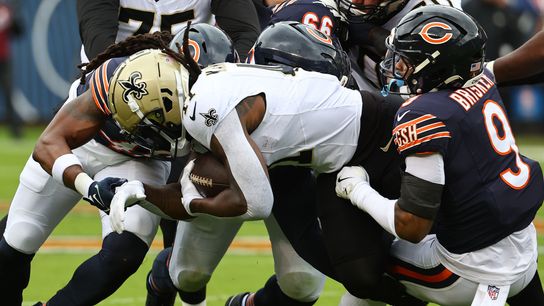 Oct 19, 2025; Chicago, Illinois, USA; Chicago Bears safety Jaquan Brisker (9) tackles New Orleans Saints running back Alvin Kamara (41) during the first quarter at Soldier Field.