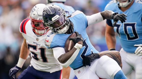 Tennessee Titans running back Tyjae Spears (2) it tripped up by New England Patriots linebacker Jahlani Tavai (48) during the first quarter at Nissan Stadium in Nashville, Tenn., Sunday, Oct. 19, 2025.