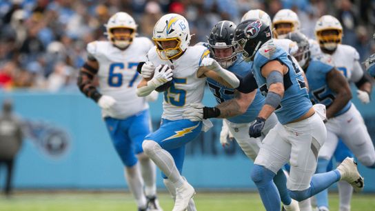 Nov 2, 2025; Nashville, Tennessee, USA; Los Angeles Chargers wide receiver Ladd McConkey (15) drags Tennessee Titans safety Amani Hooker (37) during the first half at Nissan Stadium.