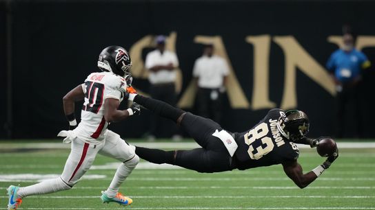 Nov 23, 2025; New Orleans, Louisiana, USA; New Orleans Saints tight end Juwan Johnson (83) makes diving catch attempt as Atlanta Falcons cornerback Dee Alford (20) defends during the first half at Caesars Superdome.