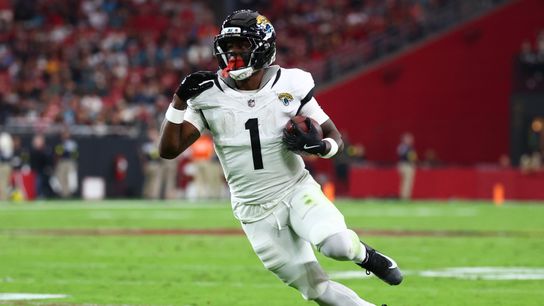 Nov 23, 2025; Glendale, Arizona, USA; Jacksonville Jaguars running back Travis Etienne Jr. (1) rushes during the first quarter against the Arizona Cardinals at State Farm Stadium.