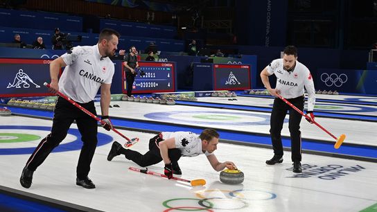 Feb 19, 2026; Cortina d'Ampezzo, Italy; Marc Kennedy of Canada, Ben Hebert of Canada and Brett Gallant of Canada in action during their match against Norway in a men's curling semifinal during the Milano Cortina 2026 Olympic Winter Games at Cortina Curling Olympic Stadium.