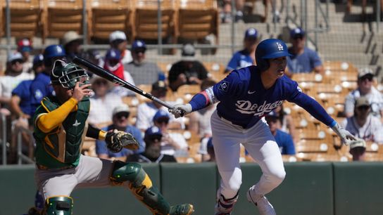Los Angeles Dodgers second baseman Hyeseong Kim (6) hits against the Athletics in the first inning at Camelback Ranch-Glendale.