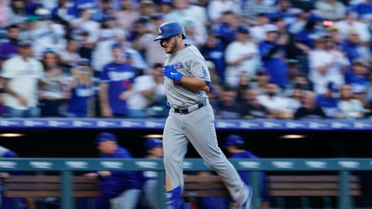 Los Angeles Dodgers third baseman Max Muncy (13) rounds the bases on a solo home run in the second inning against the Colorado Rockies at Coors Field. 