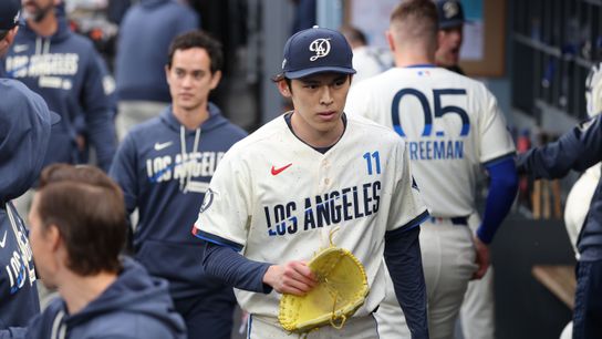 Los Angeles Dodgers starting pitcher Roki Sasaki (11) walks in the dugout after the first inning against the Chicago Cubs at Dodger Stadium. 