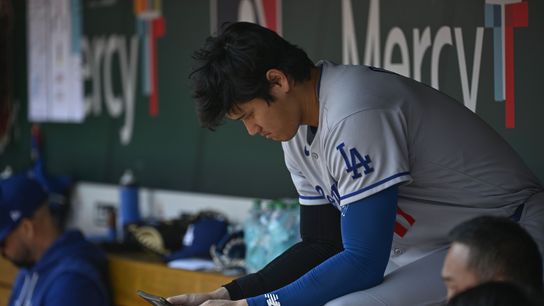 Los Angeles Dodgers designated hitter Shohei Ohtani (17) looks at a tablet during a game against the St. Louis Cardinals in the first inning at Busch Stadium. 