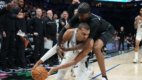 May 8, 2026; Minneapolis, Minnesota, USA; San Antonio Spurs forward Victor Wembanyama (1) tries to keep the ball away from Minnesota Timberwolves forward Jaden McDaniels (3) in the second half during game three of the second round of the 2026 NBA Playoffs at Target Center.
