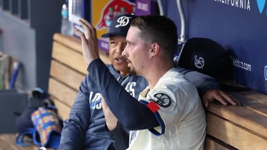 Los Angeles Dodgers pitcher Blake Snell (7) talks with manager Dave Roberts (30) in the dugout in the fourth inning against the Atlanta Braves at Dodger Stadium. Los Angeles Dodgers pitcher Blake Snell (7) talks with manager Dave Roberts (30) in the dugout in the fourth inning against the Atlanta Braves at Dodger Stadium.