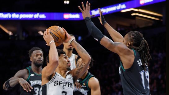 May 10, 2026; Minneapolis, Minnesota, USA; San Antonio Spurs guard Dylan Harper (2) goes to the basket between Minnesota Timberwolves forward Julius Randle (30) and guard Terrence Shannon Jr. (1) and guard Ayo Dosunmu (13) in the first quarter of game four of the second round of the 2026 NBA Playoffs at Target Center. 