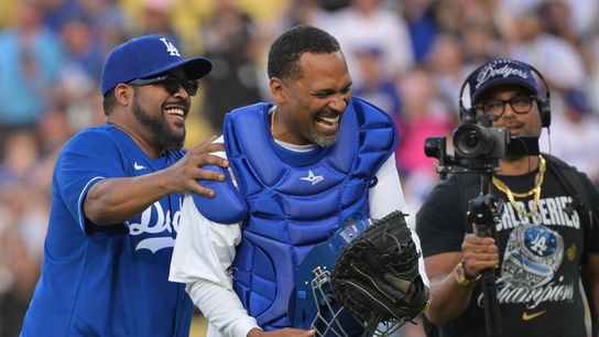 Rapper, actor and producer Ice Cube reacts with comedian and actor Mike Epps after throwing out the ceremonial first pitch before a game between the San Francisco Giants and Los Angeles Dodgers at Dod... 