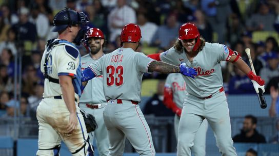 Philadelphia Phillies second baseman Edmundo Sosa (33) is greeted by Philadelphia Phillies third baseman Alec Bohm (right) after hitting a two-run home run during the eighth inning against the Los Ang... Kiyoshi Mio-Imagn Images
