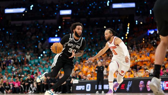 Jun 3, 2026; San Antonio, Texas, USA; San Antonio Spurs forward Julian Champagnie (30) brings the ball up court past New York Knicks guard Jalen Brunson (11) during the third quarter during game one of the 2026 NBA Finals at Frost Bank Center. 